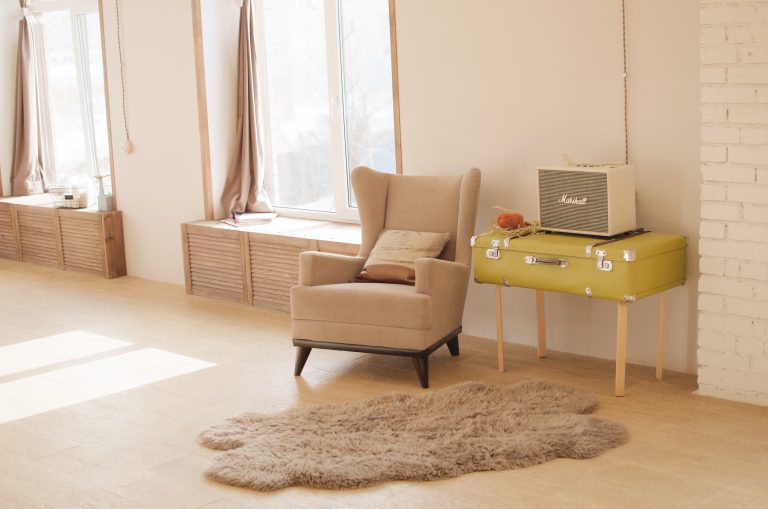 Modern property for sale showcasing a beautiful room with a cozy couch and decorative floor mats.